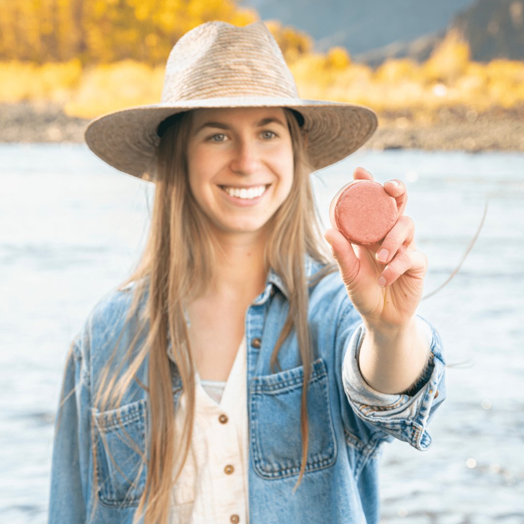 Woman holding Edenwild Nourish sulfate-free shampoo bar outdoors — plant-based solid shampoo bar for healthy hair growth and scalp health