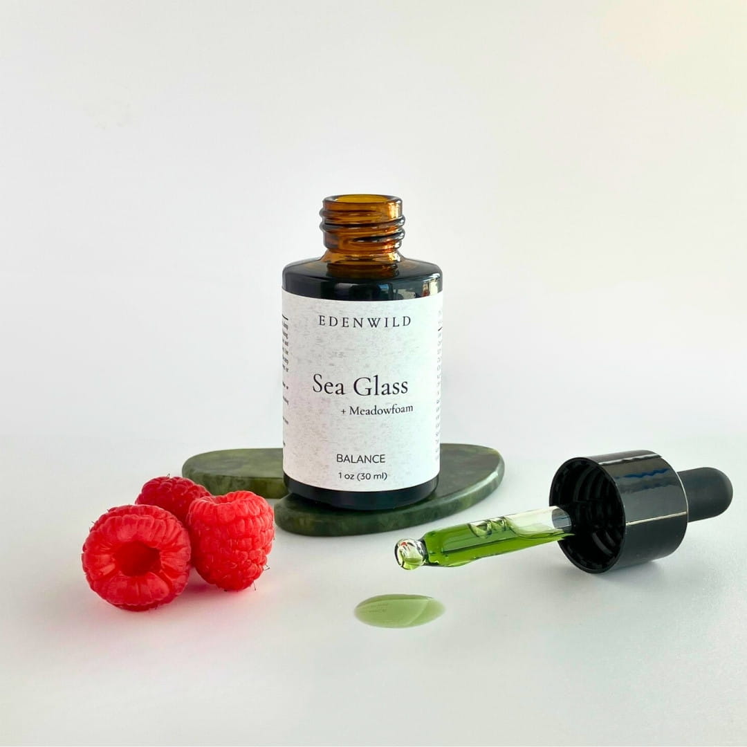 Edenwild Sea Glass Balance serum with amber dropper bottle, red berries, and matcha powder — adaptogen facial oil for skin balance and sebum regulation