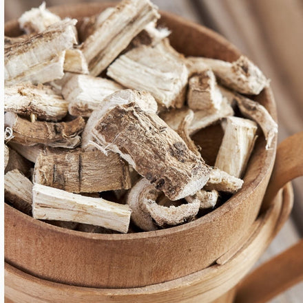 Got it! Here's the updated alt text:  **`Dried marshmallow root chunks in a wooden bowl, a soothing botanical ingredient used in natural skincare for sensitive and dry skin