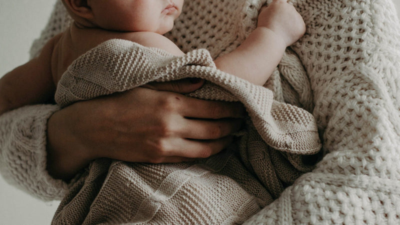  Mother applying natural tallow balm to baby's sensitive skin — Edenwild natural skincare for eczema