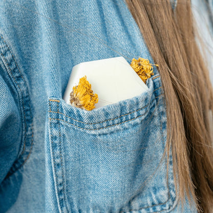 Edenwild Aire conditioner bar in denim jacket pocket with wildflower — travel-friendly solid conditioner bar for healthy, nourished hair