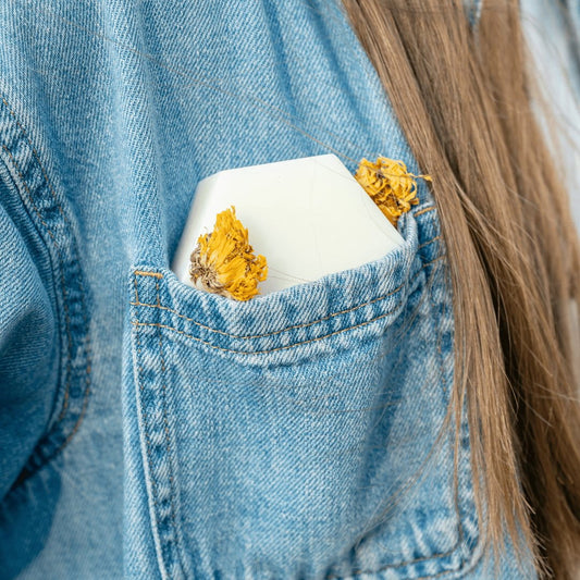 Edenwild Aire conditioner bar in denim jacket pocket with wildflower — travel-friendly solid conditioner bar for healthy, nourished hair