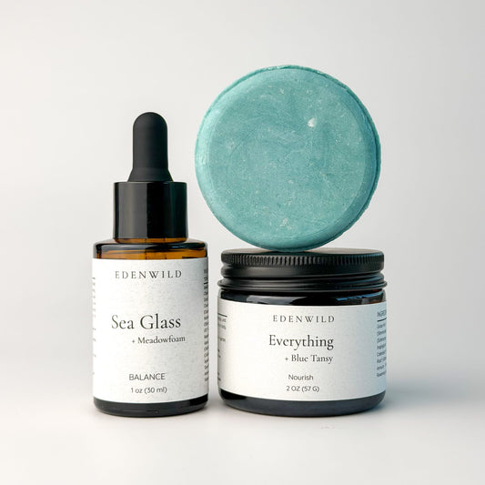 Edenwild Blue Balance Kit with Sea Glass face serum, Everything Tallow Balm with blue tansy, and Balance shampoo bar on white background