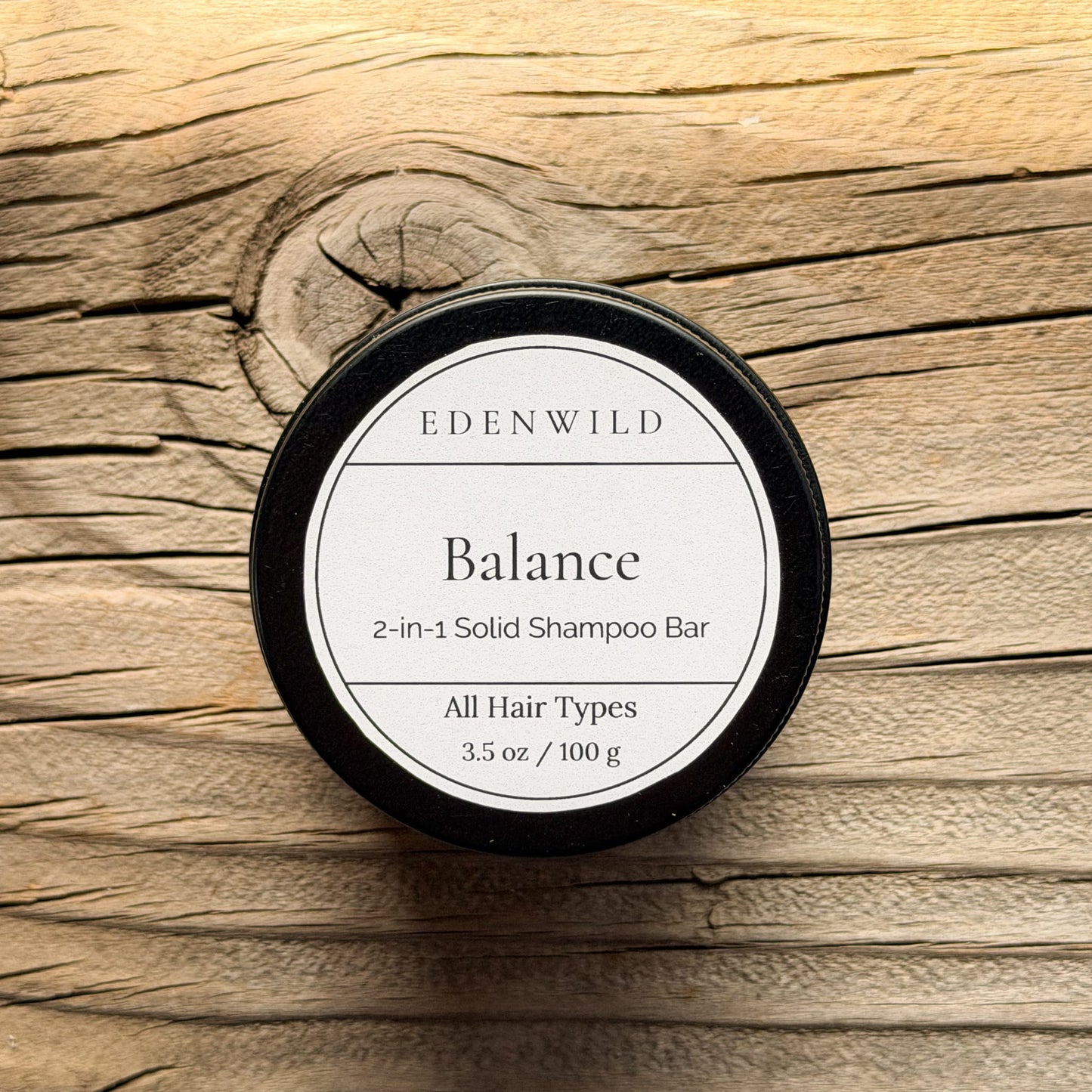 Edenwild Balance 2-in-1 Solid Shampoo Bar for all hair types, natural sulfate-free shampoo bar for oily and combination scalp, displayed on weathered wood