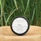 Edenwild Bare Shampoo Bar on wood stump pedestal with natural grass background — unscented colloidal oatmeal shampoo bar for sensitive scalp, fragrance-free and sulfate-free