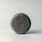 Edenwild Clarify shampoo bar in charcoal on white surface — activated charcoal sulfate-free solid shampoo bar for deep scalp cleansing and buildup removal