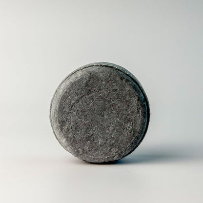 Edenwild Clarify shampoo bar in charcoal on white surface — activated charcoal sulfate-free solid shampoo bar for deep scalp cleansing and buildup removal