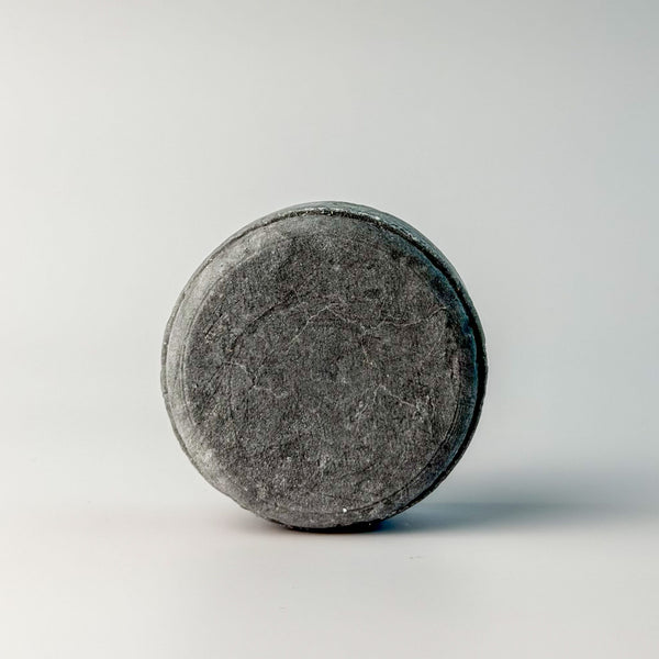 Edenwild Clarify shampoo bar in charcoal on white surface — activated charcoal sulfate-free solid shampoo bar for deep scalp cleansing and buildup removal