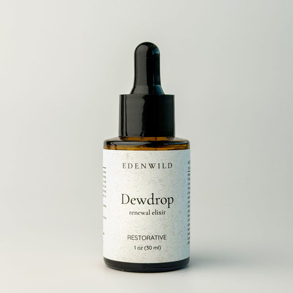 Edenwild Dewdrop Restorative facial elixir in amber dropper bottle on grey background — botanical facial serum for skin restoration and anti-aging