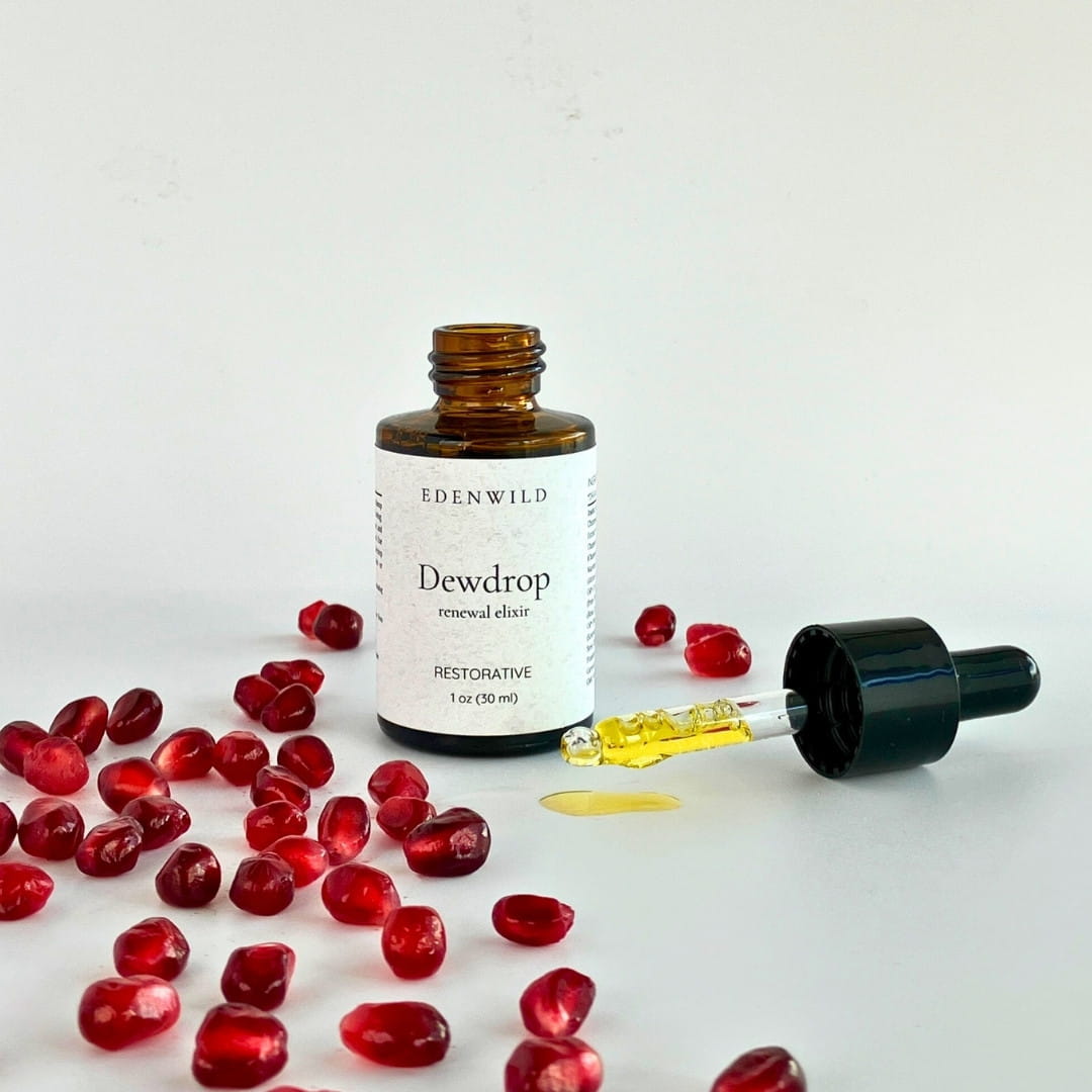 Edenwild Dewdrop Restorative facial elixir with dropper cap removed showing amber serum — pomegranate and botanical facial oil for radiant skin
