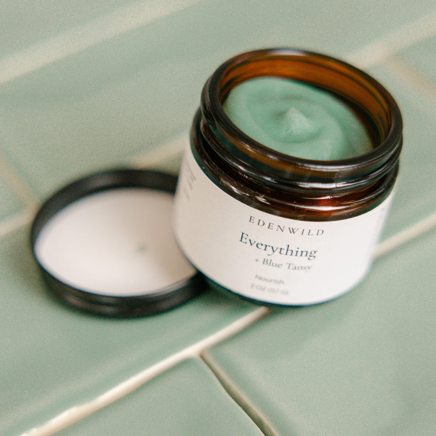 Edenwild Everything Balm on stone surface — blue tansy and grass-fed tallow balm for eczema relief and sensitive skin barrier support