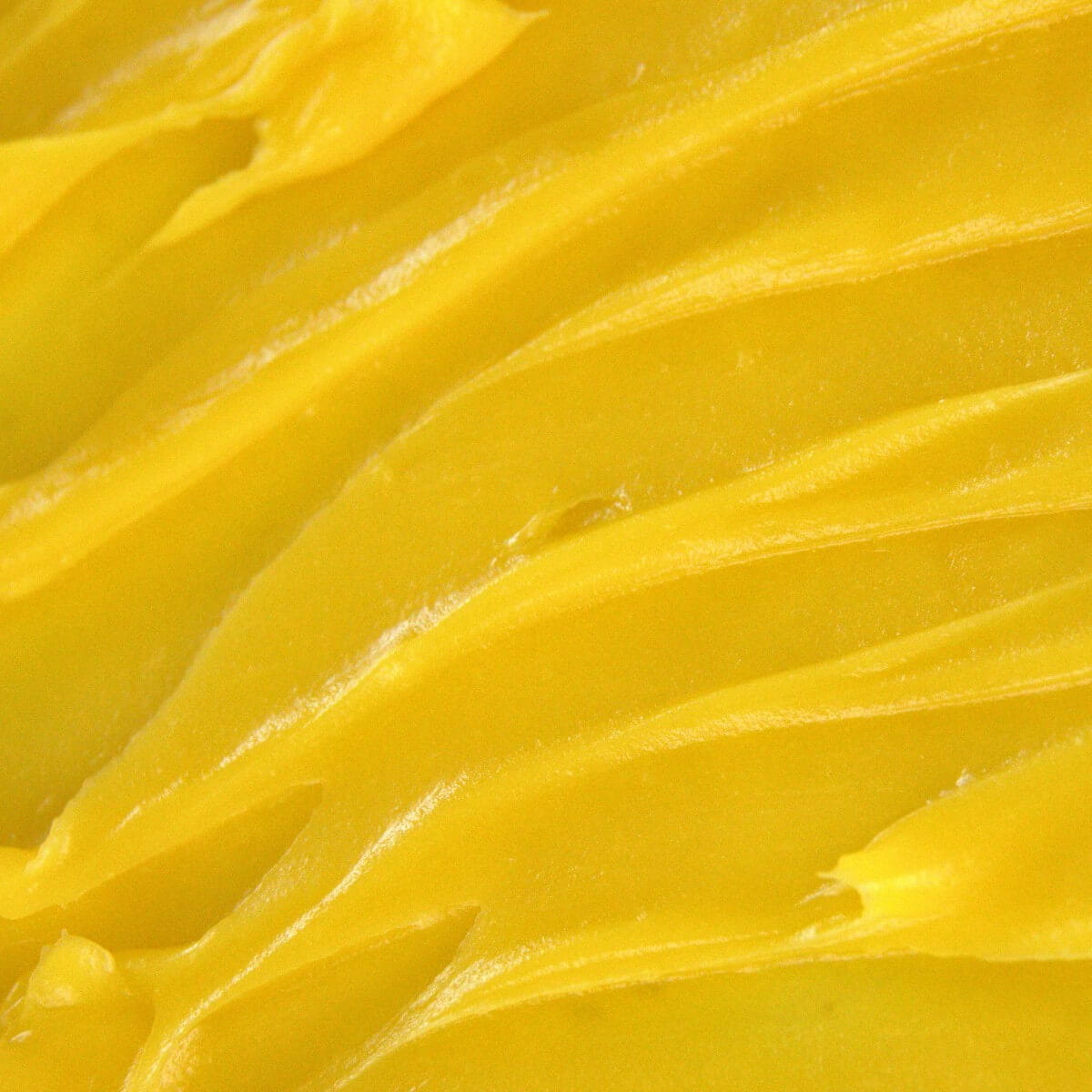 Edenwild Golden Root tallow balm texture on spatula — antioxidant-rich balm for dry skin, fine lines, and skin barrier restoration
