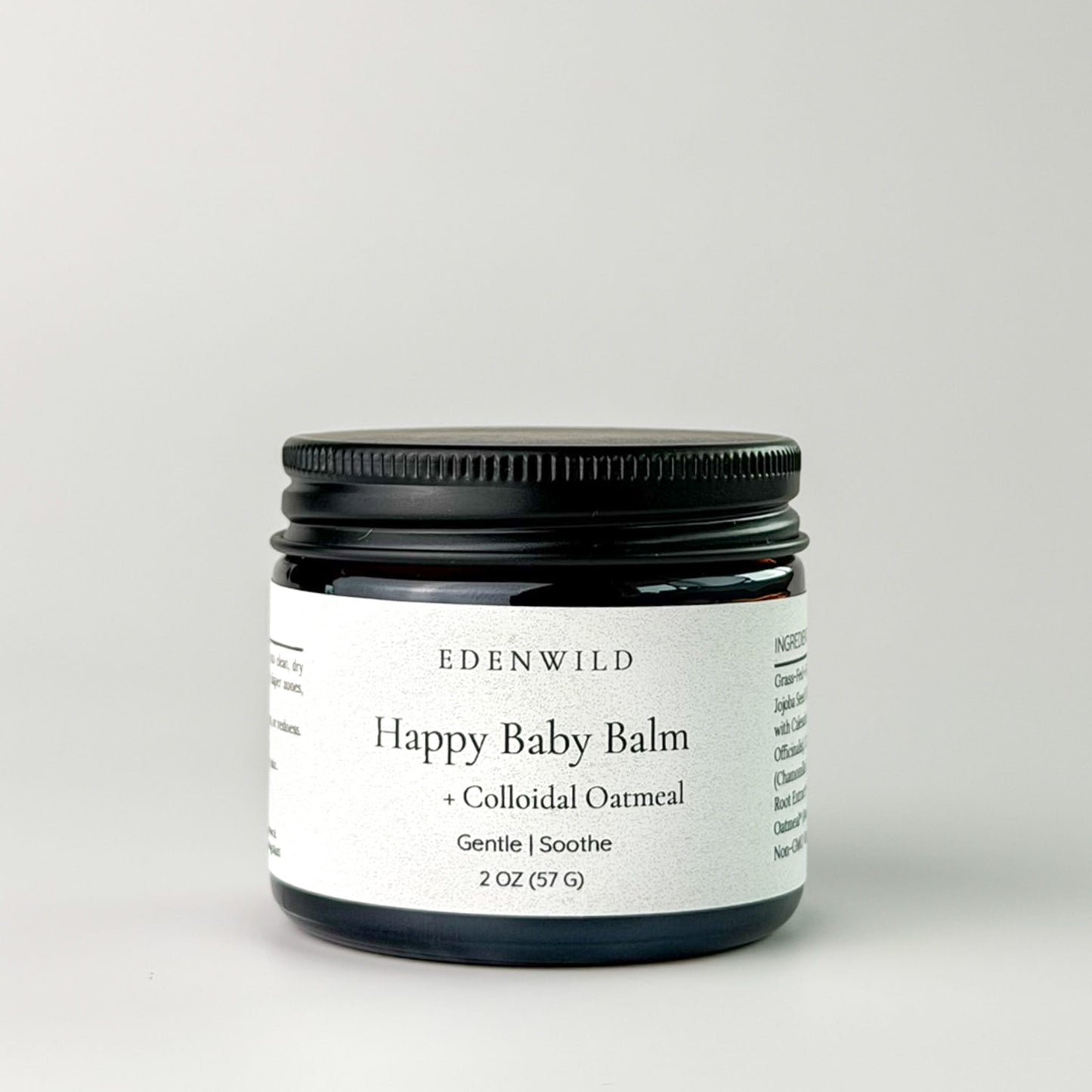 Edenwild Happy Baby Balm with colloidal oatmeal in amber jar on grey background — gentle balm for eczema, dry skin, and sensitive skin of all ages