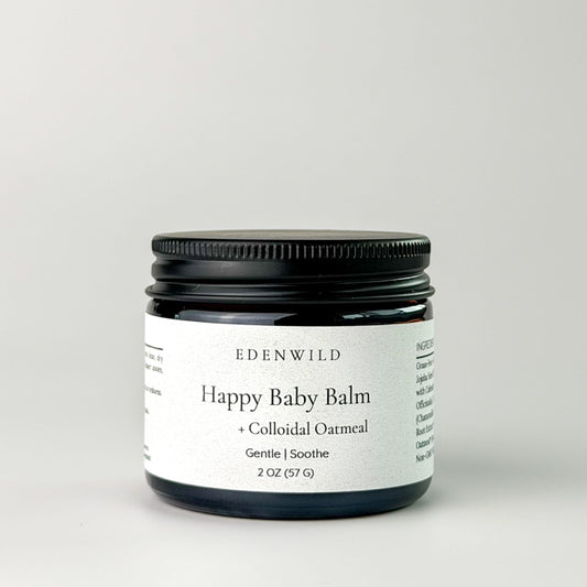Edenwild Happy Baby Balm with colloidal oatmeal in amber jar on grey background — gentle balm for eczema, dry skin, and sensitive skin of all ages