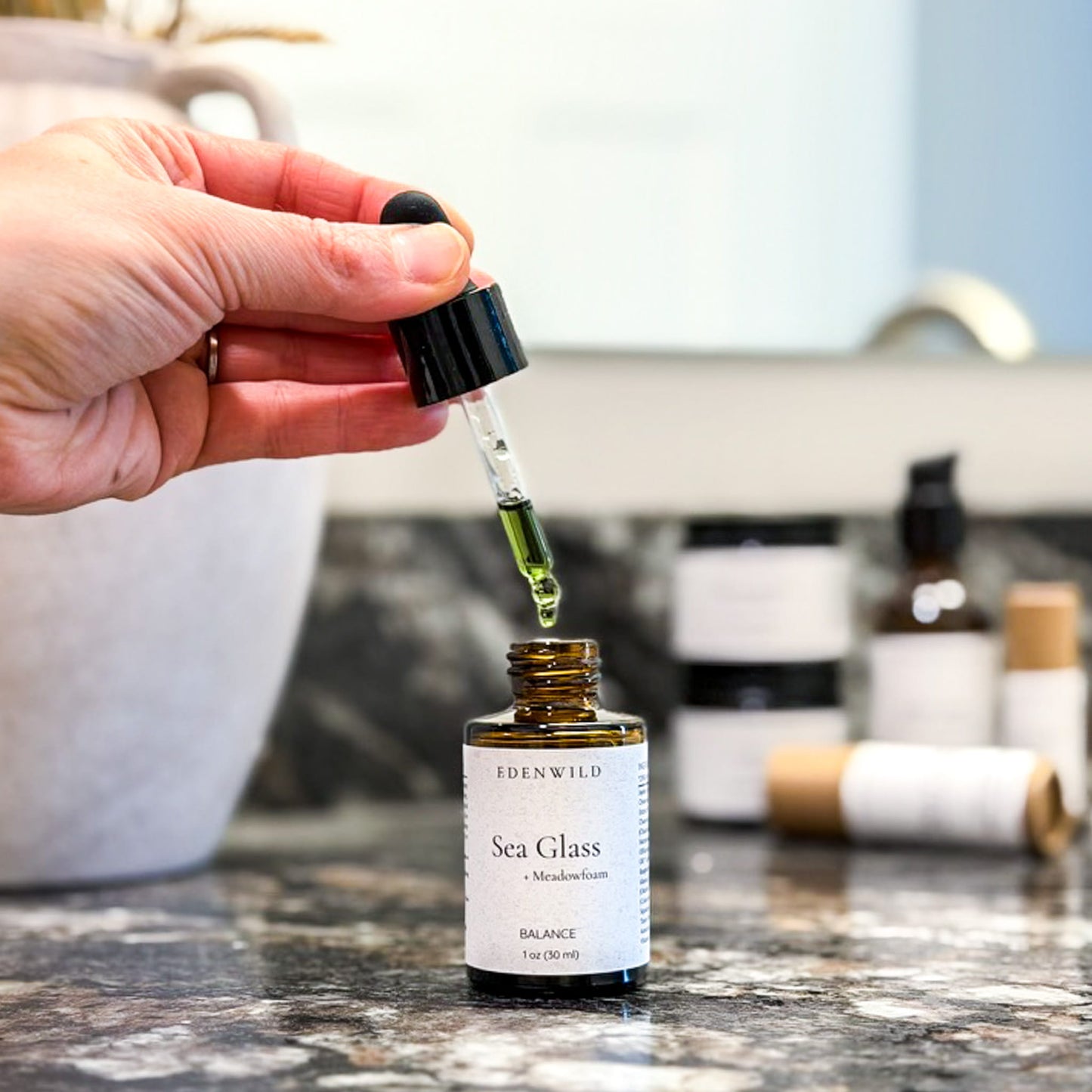 Dropper dispensing Edenwild Sea Glass with Meadowfoam seed oil facial serum to help balance and nourish skin naturally