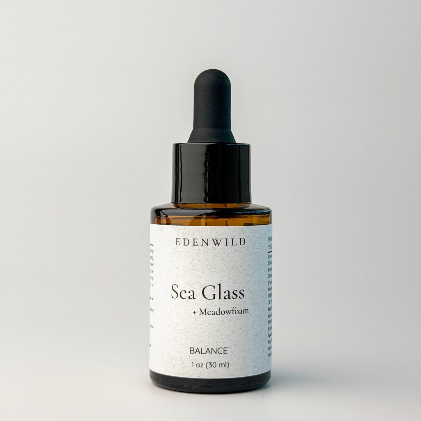 Edenwild Sea Glass serum facial serum in amber dropper bottle on grey background — botanical adaptogen serum for skin balance and barrier support