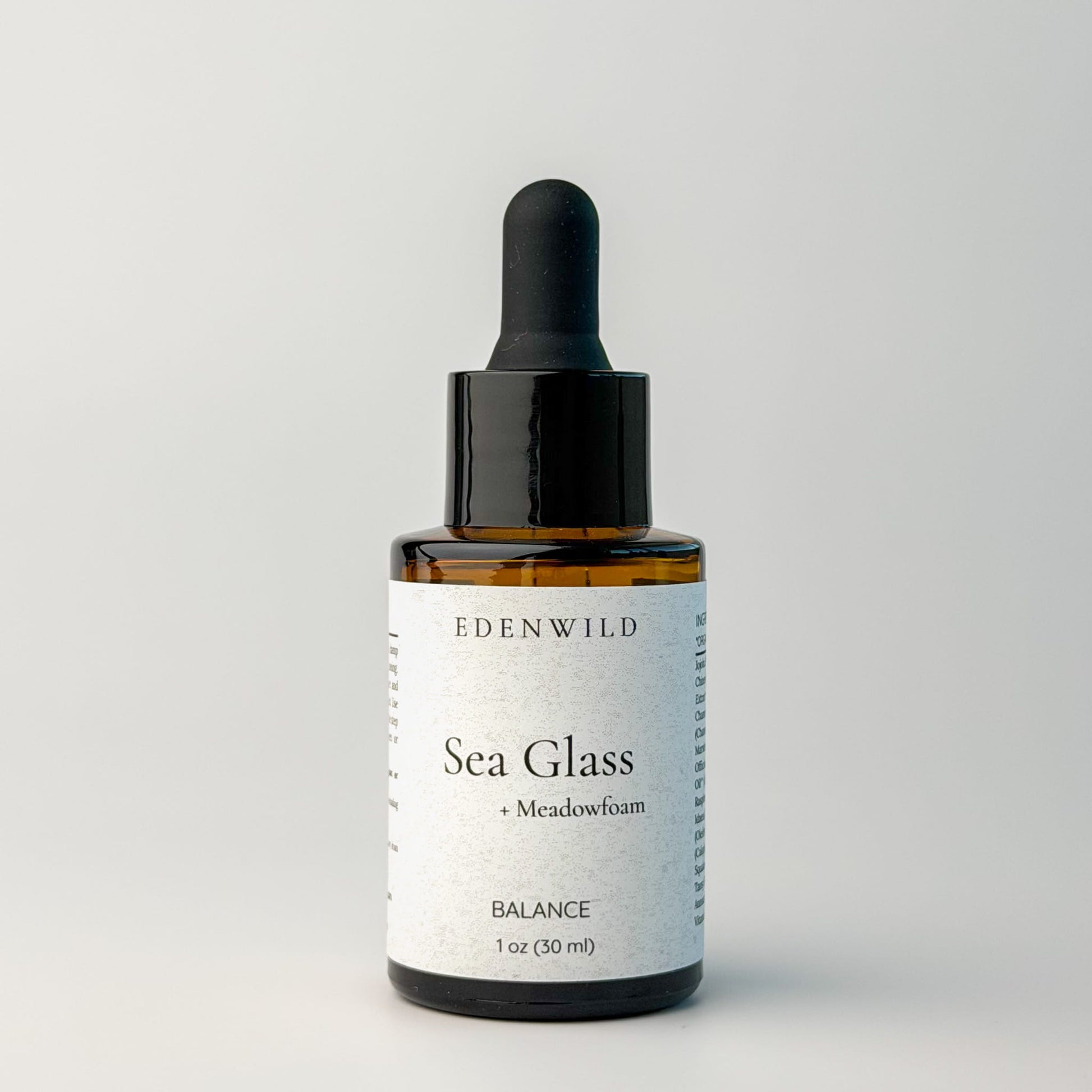 Edenwild Sea Glass serum facial serum in amber dropper bottle on grey background — botanical adaptogen serum for skin balance and barrier support
