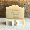 Edenwild Wild Lavender bar soap with tallow and goat milk on linen surface with dried lavender sprig — natural soap for sensitive skin