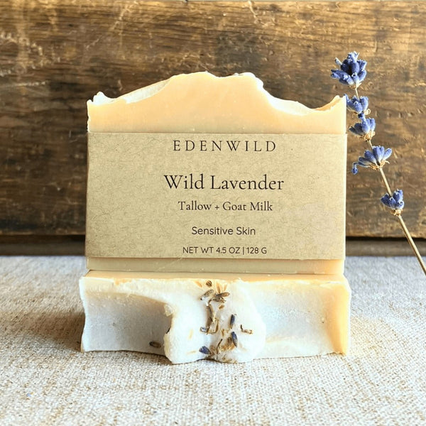 Edenwild Wild Lavender bar soap with tallow and goat milk on linen surface with dried lavender sprig — natural soap for sensitive skin